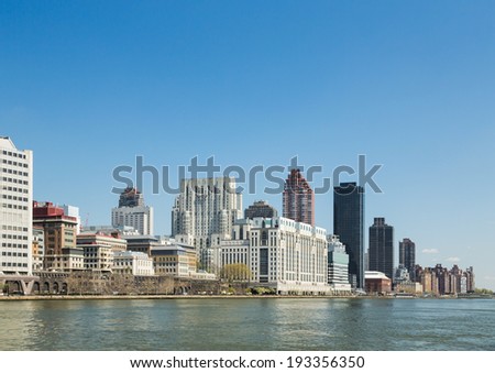 NEW YORK CITY - May: The New York City skyline from the East River on May 8, 2014 in New York, New York. New York City is bound by the East River and the Hudson River.