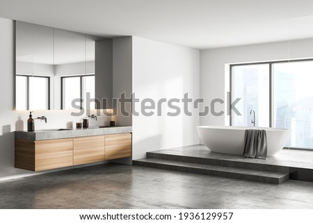 White bathroom interior with concrete floor, white bathtub and two sinks, side view. Minimalist bathroom with modern furniture and city view, 3D rendering no people