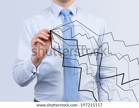 Businessman drawing line graphs