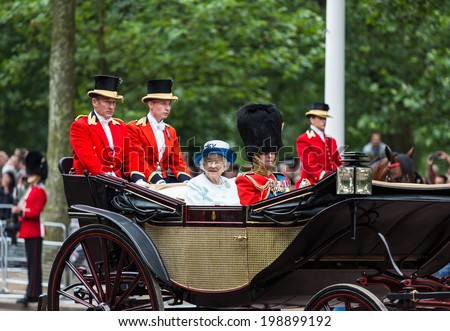 LONDON - JUNE 14: Queen Elizabeth II and Prince Philip seat on the Royal Coach at Queen\'s Birthday Parade, also known as Trooping the Colour, on June 14, 2014 in London, England.