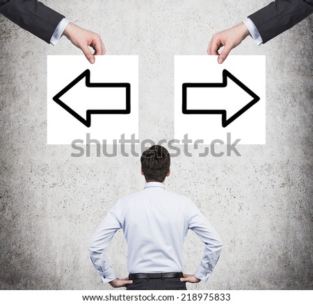 Businessman and arrows \'left or right\'