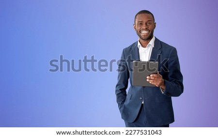 Similar – Image, Stock Photo Young black man holding wireless headphones while wearing a white sweatshirt, against a blue wall looking away with confidence. Selective focus