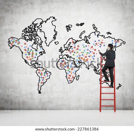 Future business developments strategy. Businessman drawing the world map and the main points to expand the business.