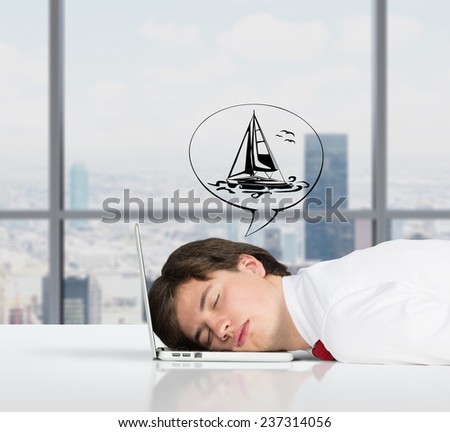 businessman sleeping on the job and dreams of travel