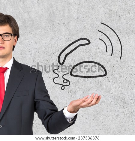 businessman holding phone on gray background