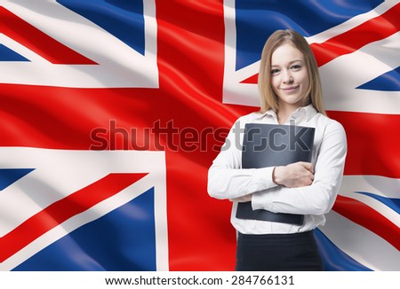 Smiling business lady in a white shirt with a black folder. Great Britain flag as a background.