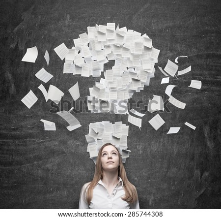 Business woman is thinking about the question mark which consists of the contract pages. Dark background.