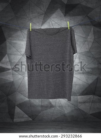 Close up of a grey t-shirts on the rope. Contemporary background.