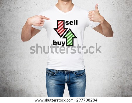Close up of the man in denims and a white t-shirt pointing out to the chest with drawn arrows: buy and sell. The concept of the capital market and investor\'s behaviour. Concrete background.
