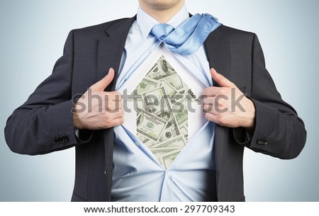 Businessman is tearing the shirt on the chest. Dollar notes under the shirt. The concept of the business soul.