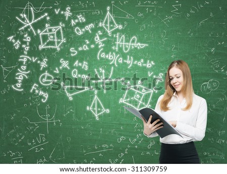 Young lady is holding a black document folder and a range of math formulas are drawn on the green chalkboard.