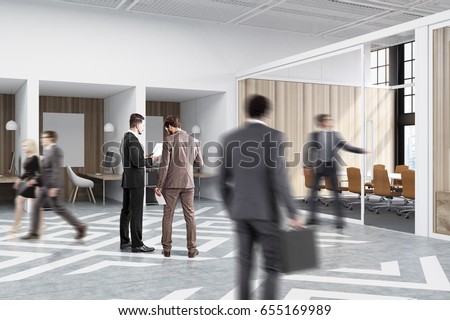 People near office cubicles in an office with white and wooden walls. There are blank vertical pictures in each of them, a desk with a computer, a chair and shelves. Stock foto © 