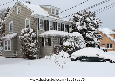 A house and a car covered with snow after nor\'easter