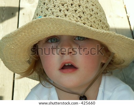 little girl in a big floppy hat