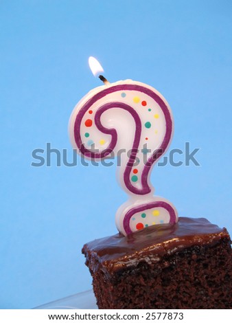 birthday cake with a question mark candle lit on top