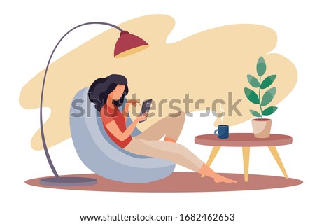 the girl sits comfortably in an armchair and works on a laptop, there is a lamp behind the armchair, a small table stands next to him and there is a room flower in a pot on it, vector illustration,