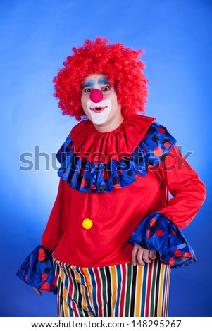Clown on blue background studio inside shot