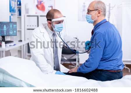 Similar – Image, Stock Photo doctor man using a syringe and a vial. using protective mask and gloves during corona virus covid 2019 pandemic. Health care and medical concept