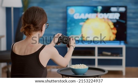 Similar – Image, Stock Photo Unhappy girl playing video game in evening time