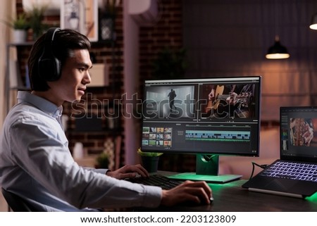 Male freelancer working on movie production with computer software, editing film montage with audio and visual effects. Creating multimedia content with footage, color grading creative app. Foto stock © 