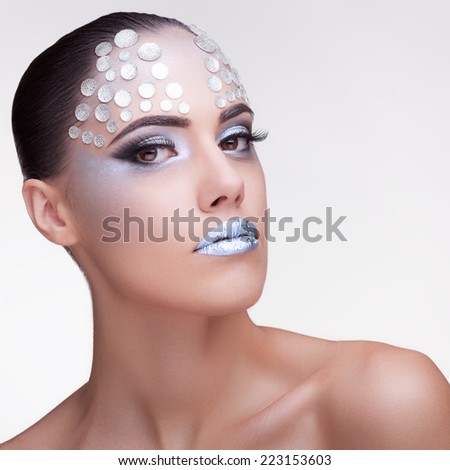 Gorgeous woman fashion rinhstone make up on grey background. Professional studio lighting