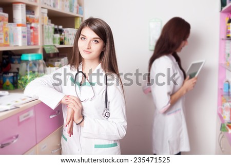 Pharmacist smiling at camera and searching something in the back of a shelf. Health care business. Business style. Lifestyle. Retail