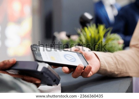 Similar – Image, Stock Photo Focused female cashier in face mask working with cash till