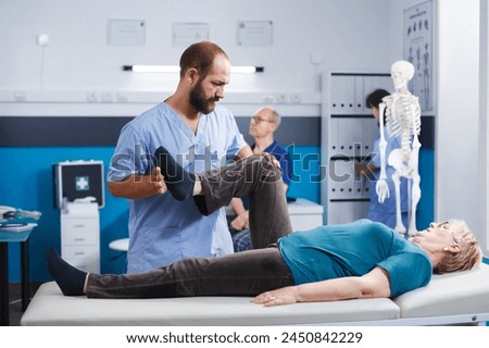 Similar – Image, Stock Photo Physiotherapist stretching leg of patient in medical room