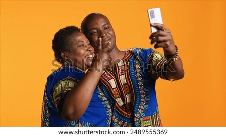 Similar – Image, Stock Photo Cheerful ethnic couple taking selfie in park