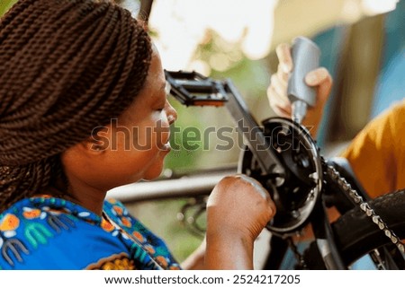 Similar – Image, Stock Photo Woman fixing bike in workshop