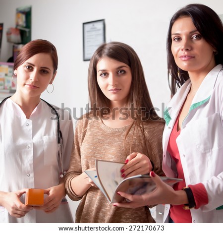 Two doctors and one client inside pharmacy. The medics are consulting the client. Customer care. Healtcare business