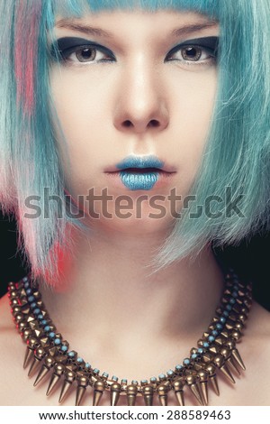 Girl with blue hair and fashion art make up. Studio shooting. Make up. Beauty and fashion
