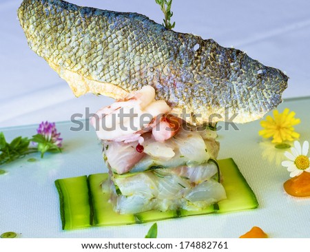 Crudites fish Dish - appetizer of raw fish adorned with flowers and herbs