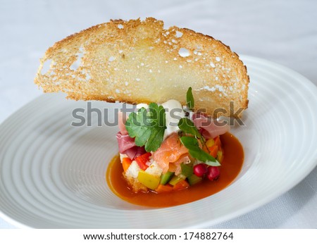 Fish dishes Marinated raw fish with vegetables chopped and toasted bread