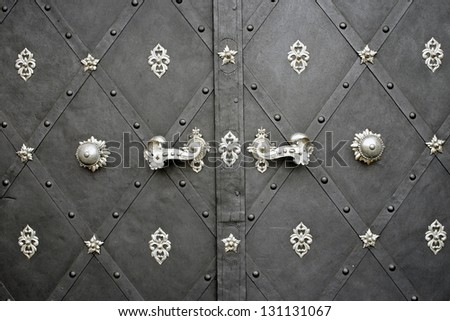Antique door with rusty floral metal work