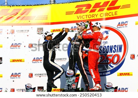 Milwaukee Wisconsin, USA - August 17, 2014: Verizon Indycar Series Indyfest. 1st Will Power,  gets champagne shower from Tony Kanaan and Juan Pablo Montoya