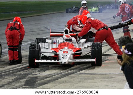 Joliet Illinois, USA - August 29, 2009: IndyCar Racing League. Pit stop during the race. Ryan Brisco driver for Penske racing. Team changes tires and fuels the car. Chicagoland speedway. Night Racing