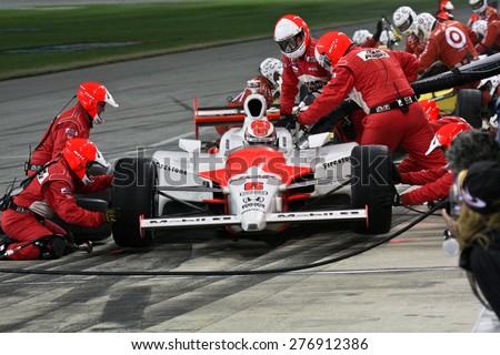 Joliet Illinois, USA - August 29, 2009: IndyCar Racing League. Pit stop. Ryan Brisco driver, Penske racing team. Team changes tires and fuels the car. Chicagoland speedway. Night Racing under lights.