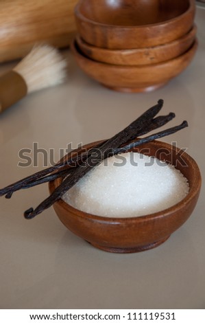 Cup of sugar with vanilla beans.