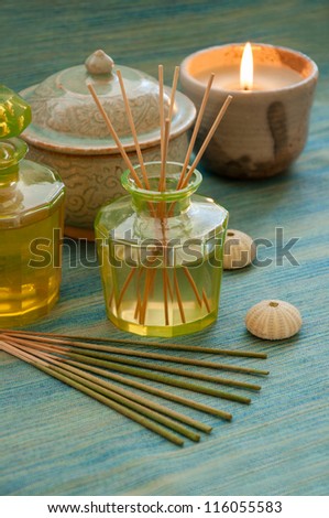 Spa concept. Bottle of fragrance reeds diffuser, aromatic essence oil, incense and candle.