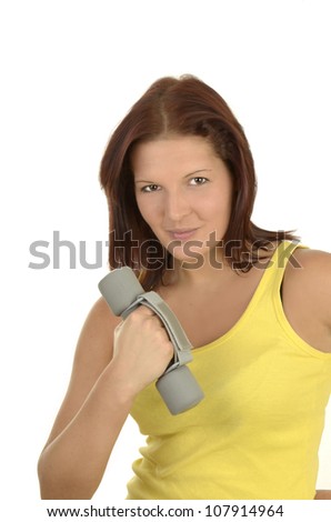 Young woman in a yellow tank top against white background during power training, isolated