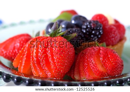 Sliced strawberries circle a gourmet berry tart.