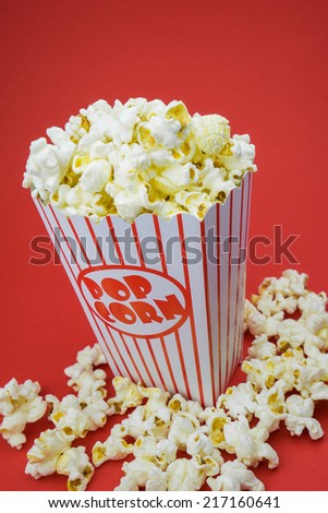 Classic box cinema popcorn on red background