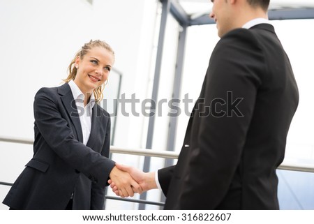 Business man and woman handshake at office