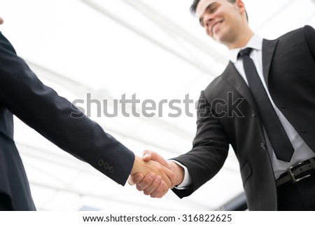 Business man and woman handshake at office
