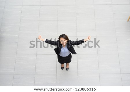 Success Asian Businesswoman sitting at her desk in an office, top view