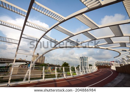 KAOHSIUNG - TAIWAN July 09: Star-of-Cianjhen Bike Bridge is located near Kaisyuan MRT station. People and bicycle can use this bridge across the Kaizuan 4th road. Kaohsiung, Taiwan. on July 09, 2014