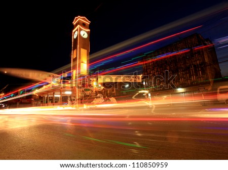Stunning light trail scenery at the clock tower in Thailand  at night.