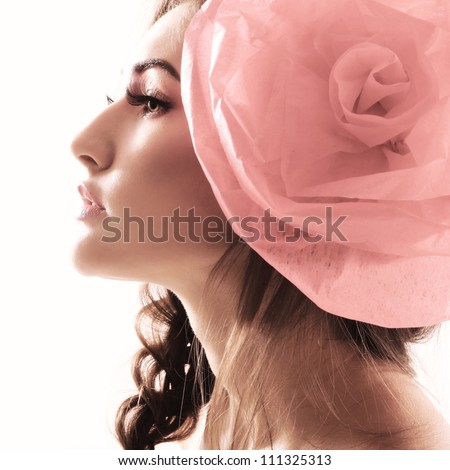 Vintage portrait of fashion glamour girl with red flower in her hair. Studio shot