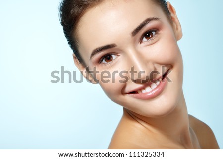 beautiful cheerful teen girl beauty face happy smiling and looking at camera over blue background